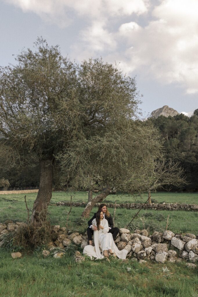 Newlyweds sharing a quiet moment under cypress trees in Italy